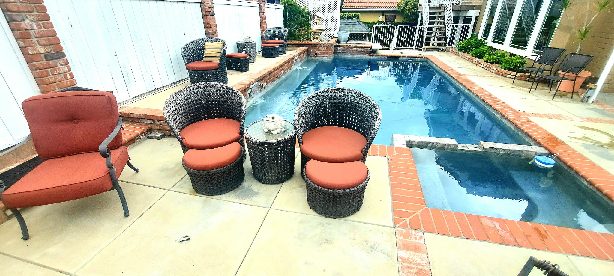 Residential pool deck and spa with brick coping